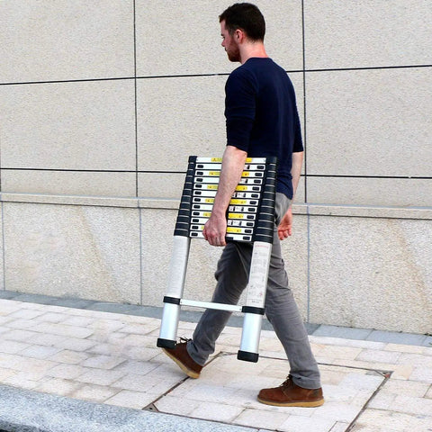 Person carrying Twelve Point Five Foot Telescoping Ladder For Home RV And Attic Use Collapsible Aluminum Alloy Extension Ladder outdoors