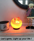 Salt lamp on table with Merry Mistletoe candle and holiday decor in cozy setting