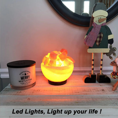 Salt lamp on table with Merry Mistletoe candle and holiday decor in cozy setting