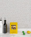 Granite Contact Paper Peel And Stick For Kitchen Countertops Cabinets And Tables Budget Friendly Waterproof Self Adhesive Vinyl Wallpaper In Grey Marble Look 36 Inch By 200 Inch Roll Removable Repositionable With No Residue applied on kitchen wall with condiments and fruit.
