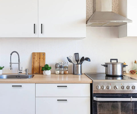 Modern kitchen featuring 60 Pack Sleek Matte Black Square Cabinet Handles Drawer Pulls For Kitchen Cabinets Wardrobe And Furniture Stainless Steel Hardware With Five Inch Center To Center Hole And Five And One Half Inch Length One Half Inch Width One Half Inch Thick on white cabinets.