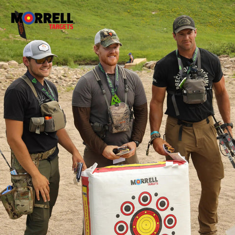 Three men standing with a Two Sided Archery Target Bag With 50 Bullseyes For Practice And Range, outdoors.