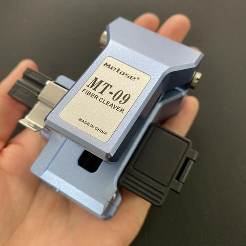 Boss Level Mt 09 Fiber Cleaver Automatic Cable Cutting Knife For Ftth Installations shown in hand, designed for precise fiber cutting.