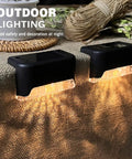 Close-up of two solar lights from 20 Pack LED Outdoor Solar Lights For Deck Fence Steps And Patio, waterproof warm white 3000K.
