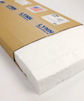 Front view of ceramic fiber insulation blanket, 2 in thick x 15 x 24 in, white block partially exposed from a brown shipping box.