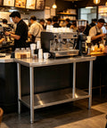 Premium 40x20 Stainless Steel Work Table Beefy Frame Heavy Duty Prep Station With Lower Shelf 600 Pound Capacity inside a busy café.