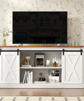 Slick Farmhouse TV Stand For 65 Inch Flat Screen Television Featuring Smooth Sliding Barn Doors And Creamy Milk White Finish, with open shelving.