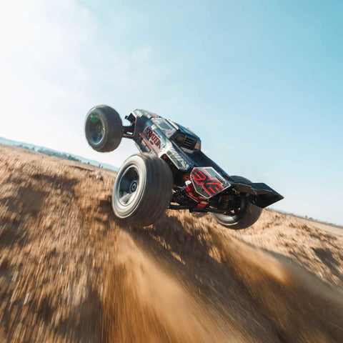 ARRMA Kraton 1 8 Scale 6S EXB Ready To Run Clipless Body Basher Monster RC Truck mid-air jump on dirt path