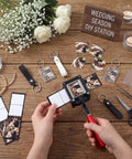 61 Piece Handheld Keychain Making Kit with 1.38x1.77 Inch Square Cutter and DIY photo inserts on a wooden table with wedding supplies