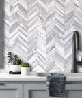 10 Sheet Herringbone Peel And Stick Backsplash In Vintage White Wood Look PVC For Kitchen And Bath DIY Friendly 12 By 12 Inch Tiles shown installed behind sink