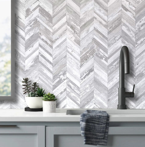 10 Sheet Herringbone Peel And Stick Backsplash In Vintage White Wood Look PVC For Kitchen And Bath DIY Friendly 12 By 12 Inch Tiles shown installed behind sink