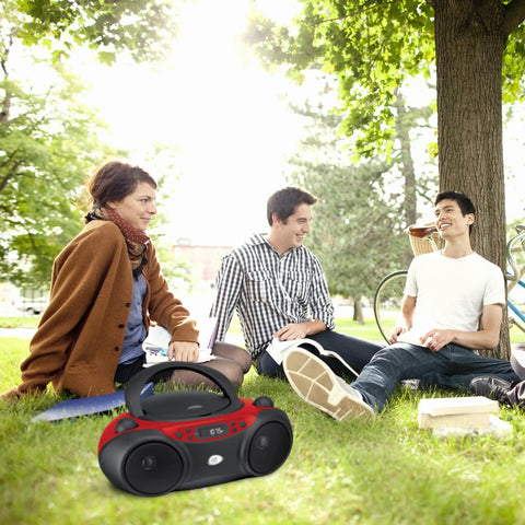 Portable Top-Loading CD Boombox With AM/FM Radio and 3.5mm Line In, red and black, in park setting with group of people outdoors