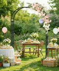 Adjustable Garden Arch Trellis 4.9x8.5 Ft Metal Outdoor Arbor For Climbing Plants, flower-decorated in a backyard setting