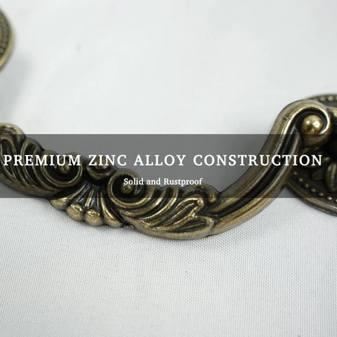 Close-up of Six Pack Antique Brass Drawer Pulls With Four And Three Quarters Inch Hole Centers, floral design, zinc alloy material