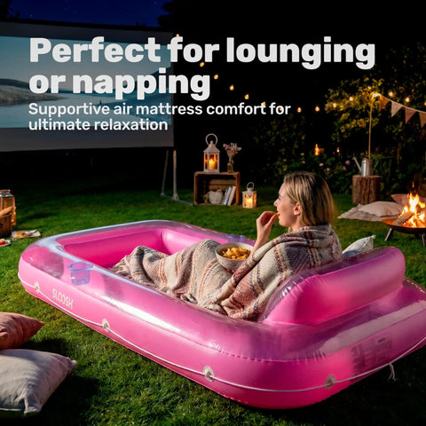Person relaxing on Inflatable Tanning Pool Lounger With Pillow 70 By 46 Inches in backyard at night.