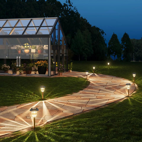 Outdoor Solar Lights 4 Pack Waterproof Garden Pathway Driveway Yard Lights With Auto On Off, illuminating a garden path at night.