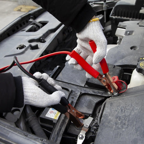 Compact Car Emergency Roadside Kit with jumper cables connected to car battery