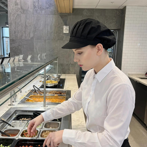 Top Shelf Three Pack Chef Hats For Women And Men With Brimmed Elastic Fit Breathable Poly Cotton Kitchen Cooking Caps For Restaurant Shifts And Weekend Cookouts, black chef hat worn by woman in kitchen.