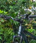 Close-up of 620mm Aluminum Mountain Bike Handlebar 25.4 Clamp Riser with 30mm rise on a forest path