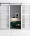 Sliding Double Barn Doors Featuring Frosted Glass And Nordic White Finish 42 By 96 Inches with stainless steel hardware in modern living room.
