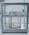 Built Tough Stainless Steel Ultrasonic Cleaner Basket With Fine Mesh Liner And Easy Grip Swing Handle in clear cleaning tank.
