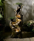 Outdoor 5 Tier Cascading Water Fountain With Realistic Tree Trunk Look, Resin Imitation Wood, LED Accent Lights at night