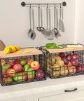 Keep Your Counters Tight With This Solid Stackable Wire Basket Set Designed To Sweep Up Kitchen Clutter While Offering Plenty Of Room For Sorting Fresh Produce Spices And Snacks. Two stackable black wire baskets filled with apples and potatoes, featuring bamboo tops.