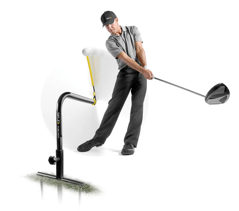 Golfer using Pure Path Golf Swing Trainer Yellow Large For Immediate Swing Path Feedback, no net needed, ground-stakes setup