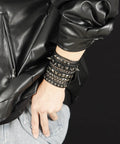 Badass 3 Piece Punk Gothic Leather Bracelet Set With Vintage Steampunk Spikes And Rivets Wide Adjustable Cuff Wristbands For Men And Women Daily Wear Gear worn on wrist with black leather jacket.