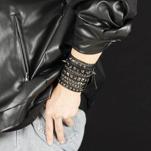 Badass 3 Piece Punk Gothic Leather Bracelet Set With Vintage Steampunk Spikes And Rivets Wide Adjustable Cuff Wristbands For Men And Women Daily Wear Gear worn on wrist with black leather jacket.