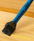 Blue Easy Clean Silicone Glue Spreader for Biscuit Joinery with dual end applying glue on wood surface, close-up