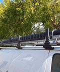 Van roof rack for secure transportation with tree backdrop