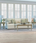 Living room featuring 28.25 Inch Tall Porcelain Table Lamp With Teal And Taupe Two Tone Finish and white linen French drum shade