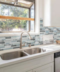 Self Adhesive Kitchen Backsplash Tiles With Marble Look For Quick Kitchen Remodel installed above a sink in a modern kitchen.