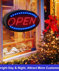 Led Open Sign 23 By 14 Inch With Remote Control Ultra Bright Customer Magnet Electric Display Light Two Modes Flashing And Steady Perfect For Business Shop Bar Hotel Restaurant Windows, hanging in a festive window display.