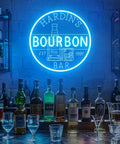 Personalized Bourbon Bar Neon Sign LED Wall Decor in home bar setup with liquor bottles on countertop and dim ambiance