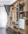 Level Up Your Interior With This Badass Heavy Duty Sliding Barn Door Kit Featuring Complete Rolling Rail Set For Indoor Loft Vibes Steel Round Tube Track And No Sweat Installation. Two wooden barn ladders mounted on black sliding rail against modern wooden shelves.