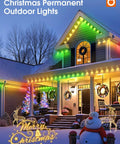 House decorated with colorful permanent outdoor Christmas lights, illuminated in the evening, with snowman and festive trees.