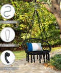 Black macrame hammock chair swing hanging from tree, showing cushioned seat and hardware kit items for indoor outdoor chill.