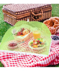 5 Pack Mesh Food Cover Tents For Picnics And Barbecues covering fruit and juice on a picnic blanket