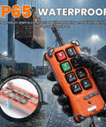 Eight Button Wireless Crane Remote Control For 12V Lift With Two Transmitters Industrial Channel Electric Hoist Radio Switch Receiver held by gloved hand in rain, showing IP65 waterproof rating
