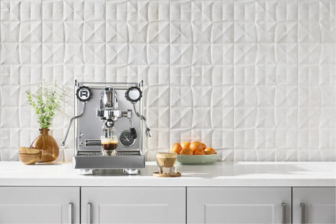 Professional Grade Kickass Heat Exchange Espresso Machine With Longer Steam Wand And Deep Drip Tray Upgraded Glow Interface For Smooth Daily Pulls Black Copper Edition with brewed espresso on white countertop.