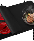 Heat Resistant Glass Stovetop Cover For Electric Stoves 21 By 29 Point 5 Inches Fireproof Waterproof Shield That Keeps Scratches And Mess Off Your Stovetop Surface Black, covering a red-lit stove