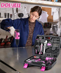 Woman using Pink 147 Piece Tool Kit With Twelve Volt Cordless Drill And Three Eighth Inch Keyless Chuck Built In LED Type C