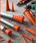 Heavy Duty 56 Piece Hydraulic Oil Service Plugs Set In Orange, Large Medium Small Sizes next to tools on concrete surface