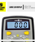 Close-up of Segomo Tools 500 Volt Digital Multimeter With Backlit LCD Display showing LCD screen for AC and DC testing in dim light.