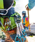 Climber with Sm'D Carabiner With TRIACT-LOCK on harness, lightweight D-shape climbing biner in bright yellow, quickdraw setup
