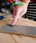 Hand using Dia Sharp Diamond Knife Sharpener Bench Stone For Home Shop And Jobsite Coarse 325 Grit Flat Diamond Surface