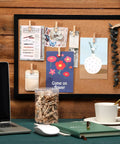 100 Piece Natural Wood Push Pin Clip Set Includes Clear Tube To Tidy Up Papers And Memos No Fuss Thumb Tacks For Clean Desk Setup Goals displayed on a cork board.