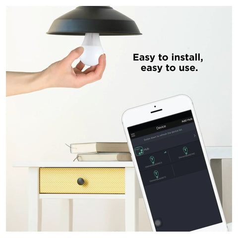 Person installing Zigbee A19 Daylight LED Light Bulb, 8 Pack, 60W Equivalent, Hub Required, shown with smart device control app.